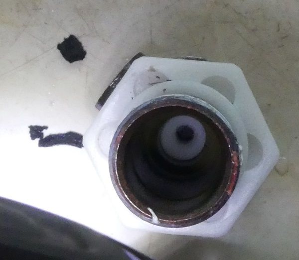 The bits of broken washer removed from the inlet to the float valve.